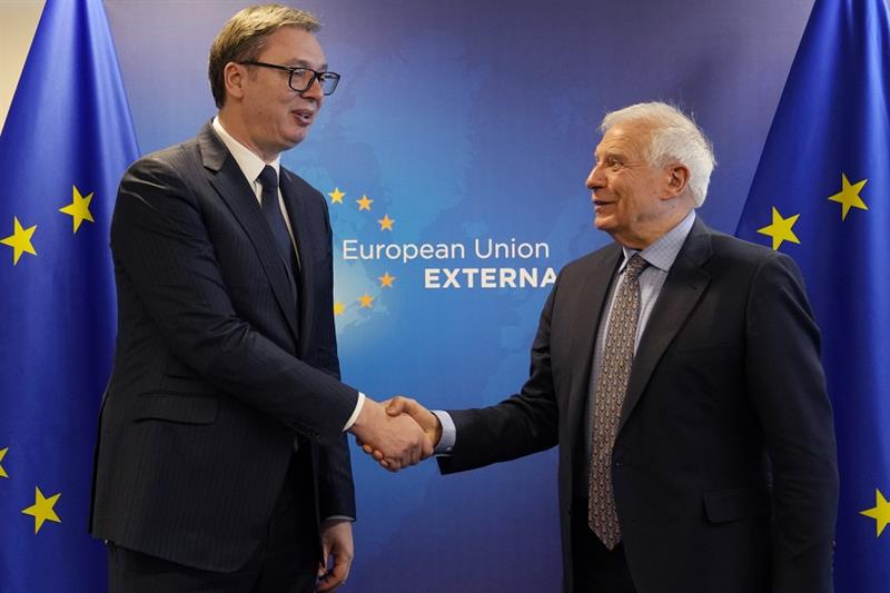 Serbian President Aleksandar Vucic, left, shakes hands with European Union foreign policy chief Jose