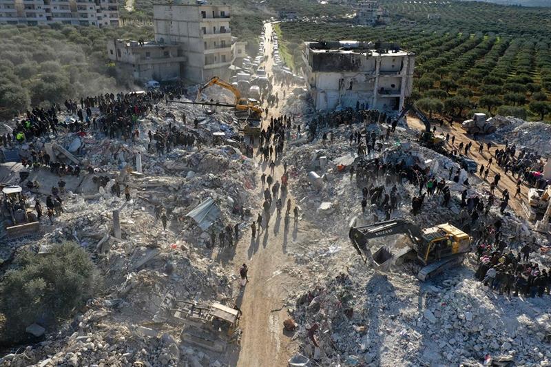 An aerial picture shows rescuers searching the rubble of buildings for casualties and survivors in t