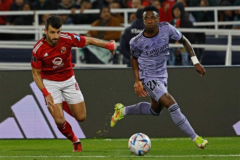 Real Madrid s Brazilian forward Vinicius Junior (R) is marked by Ahly s Egyptian defender Mahmoud Me
