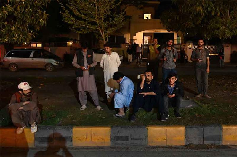 People gather outside a mall following an earthquake in Islamabad, Pakistan, on March 21, 2023. AFP