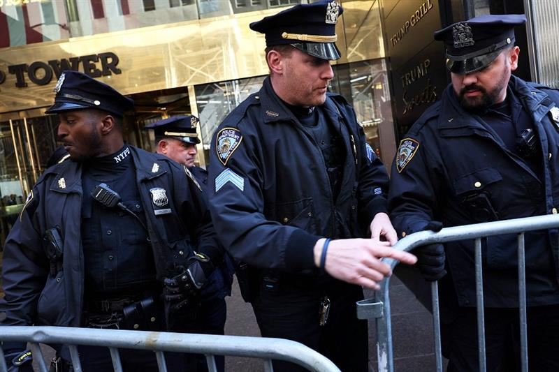 NYPD officers place metal barricades outside of Trump Tower on March 21, 2023 in New York City. 