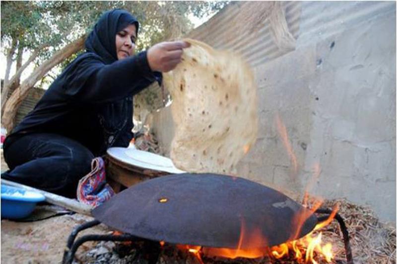 A Bedouin  making traditional bread in Sinai