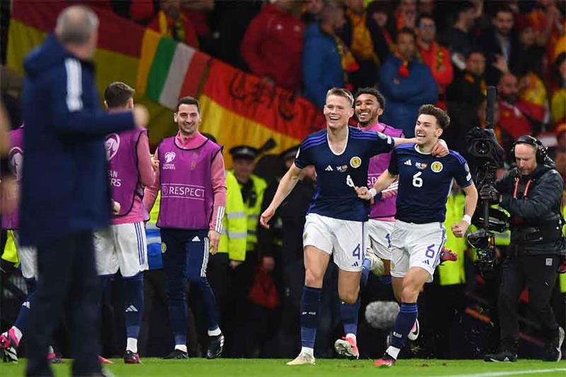 Scotland s midfielder Scott McTominay (L) celebrates scoring the team s second goal with Scotland s 