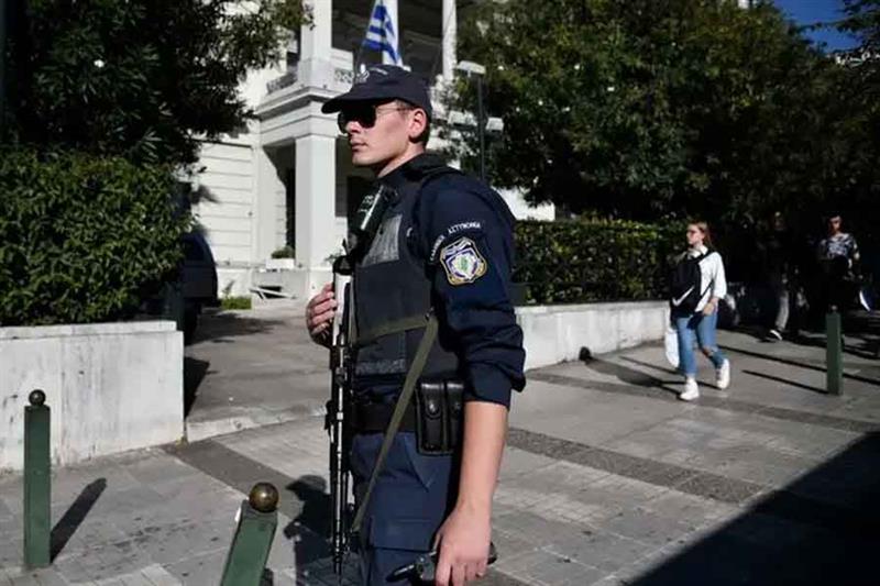 A police officer stands guard outside the foreign ministry building in Athens, Greece. AFP