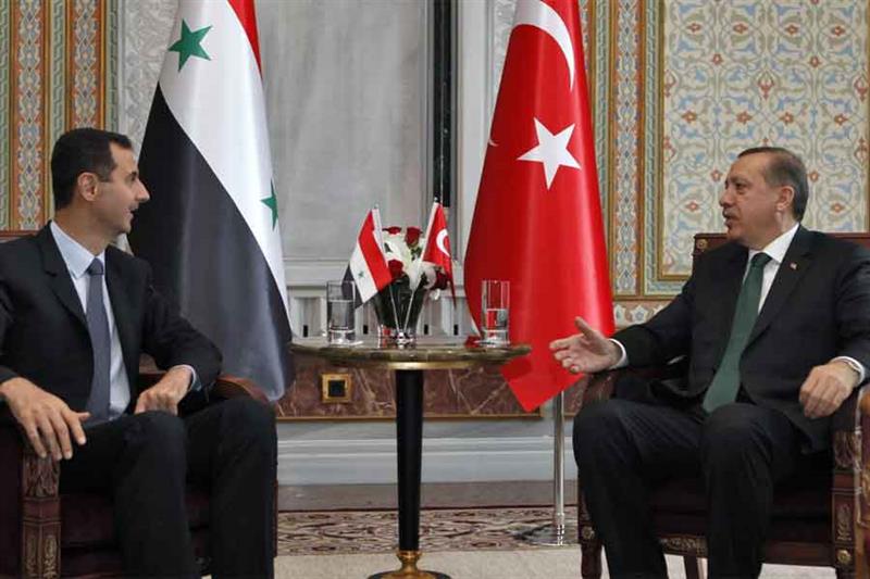 Then Turkey s Prime Minister Tayyip Erdogan (R) talks with Syria s President Bashar al-Assad during 