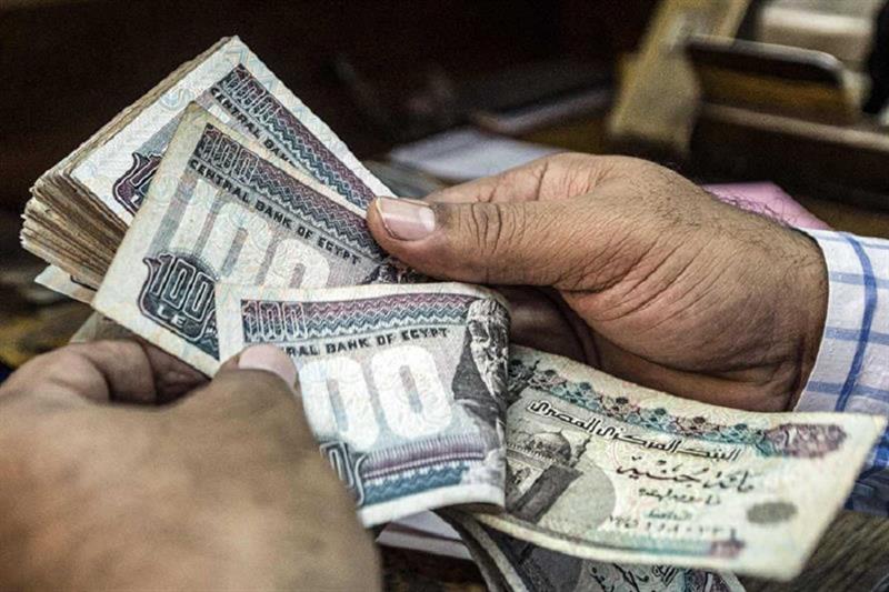 In this file photo a man counts Egyptian pounds at currency exchange shop in downtown Cairo. AFP