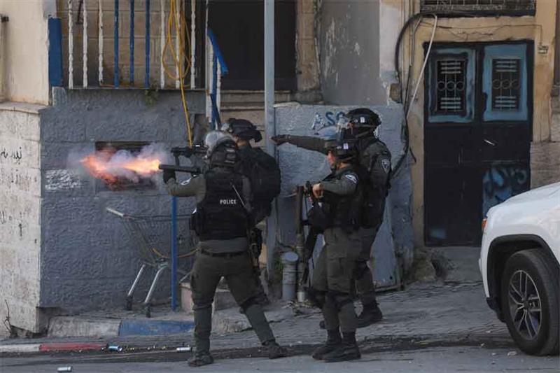 Israeli security forces use tear gas to disperse Palestinians protesting against the demolition of h