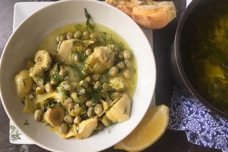 Artichoke hearts and green fava beans in dill sauce