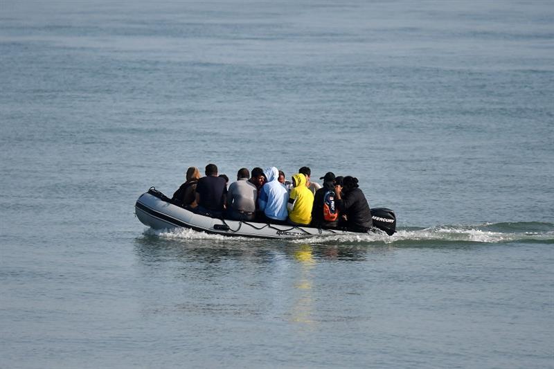 Migrants travel by inflatable boat as they reach the shore near Deal on the south east coast of Engl