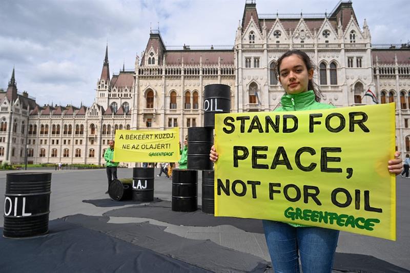 An activist of independent global campaigning network Greenpeace holds a banner reading  Stand for p