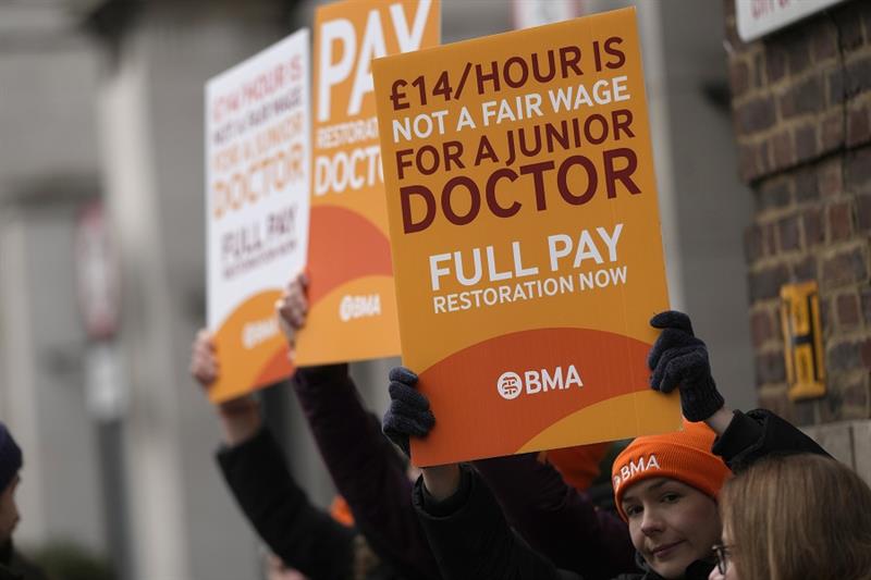 Junior doctors hold placards on a picket line outside St Mary s Hospital in London, Tuesday, March 1