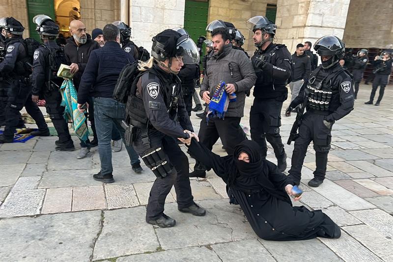 Israeli security forces remove Palestinian Muslim worshippers sitting on the grounds of the Al-Aqsa 