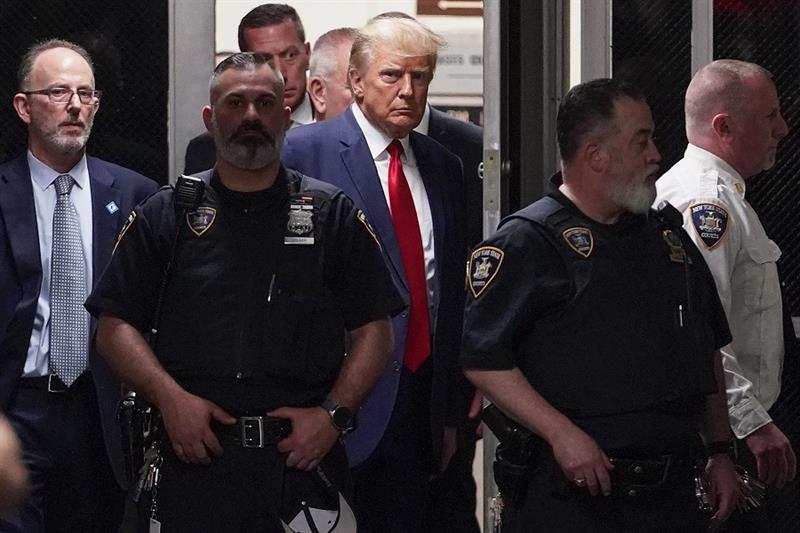 Former President Donald Trump is escorted to a courtroom, Tuesday, April 4, 2023, in New York. 