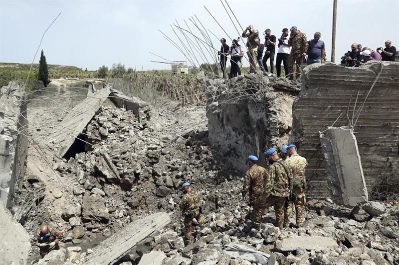 Italian U.N. peacekeeper soldiers inspect a small bridge that was destroyed by an Israeli airstrike,