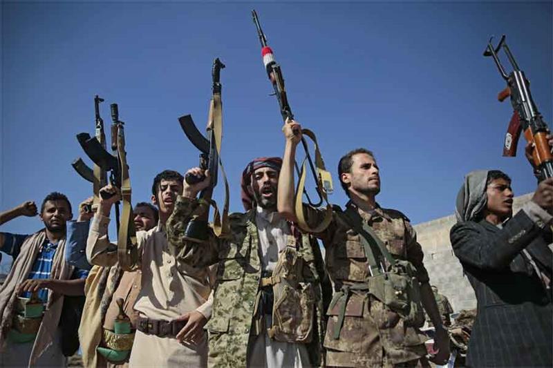 FILE - In this Dec. 13, 2018, file, photo, tribesmen loyal to Houthi rebels hold up their weapons as