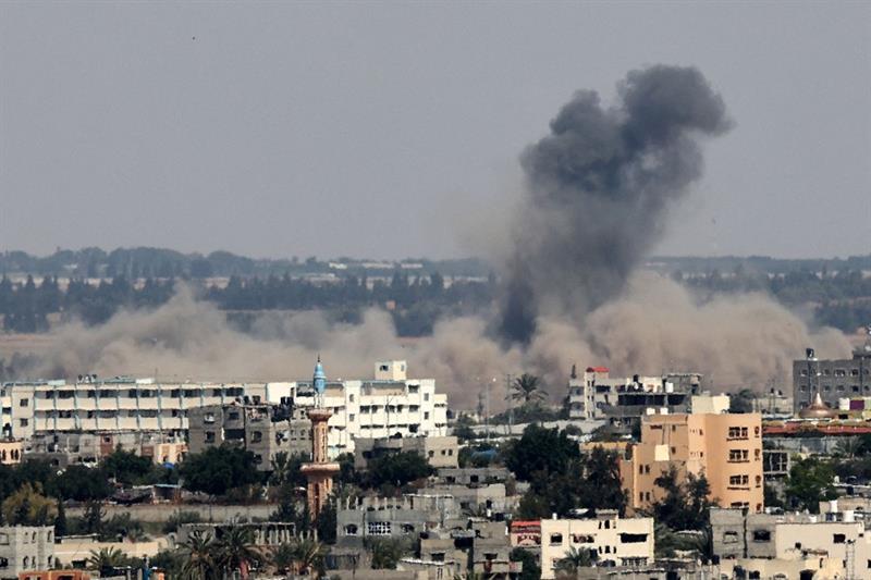  A plume of smoke rises above buildings during an Israeli strike east of Rafah, in the southern Gaza