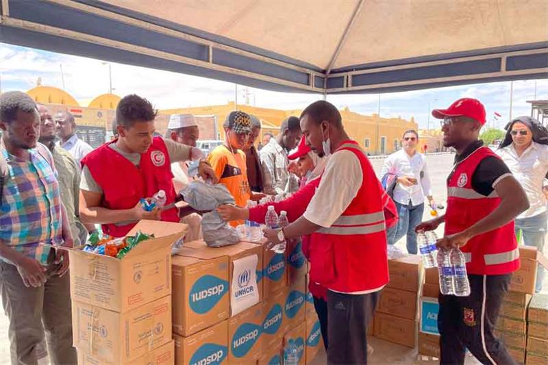 A file photo of Egyptian Red Crescent volunteers distributing water and food to Sudanese refugees at