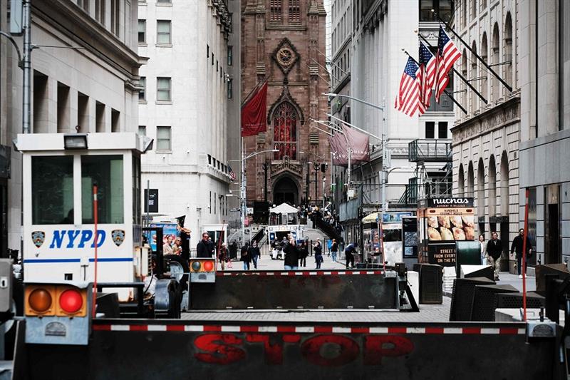 People walk along Wall Street outside of the New York Stock Exchange (NYSE) on May 03, 2023 in New Y