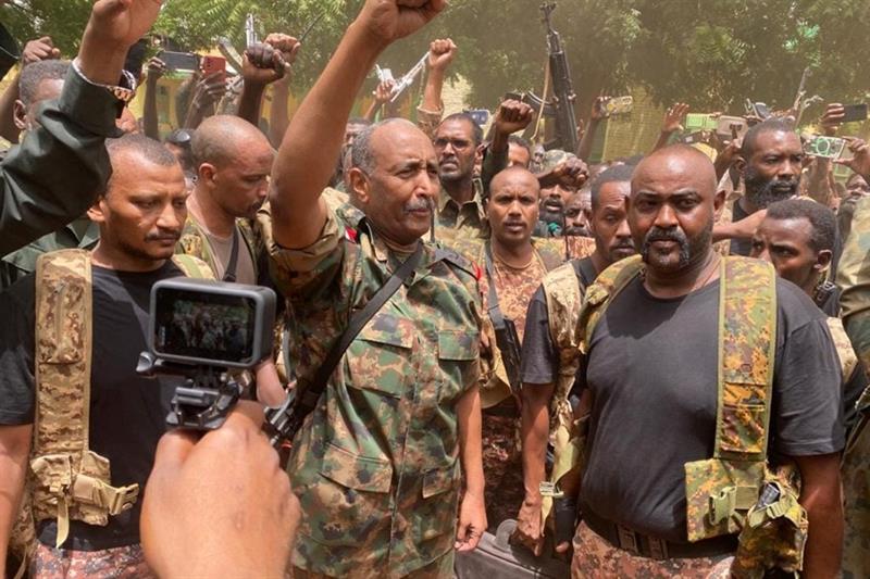 Sudanese army chief Abdel Fattah al-Burhan cheering with soldiers in Khartoum