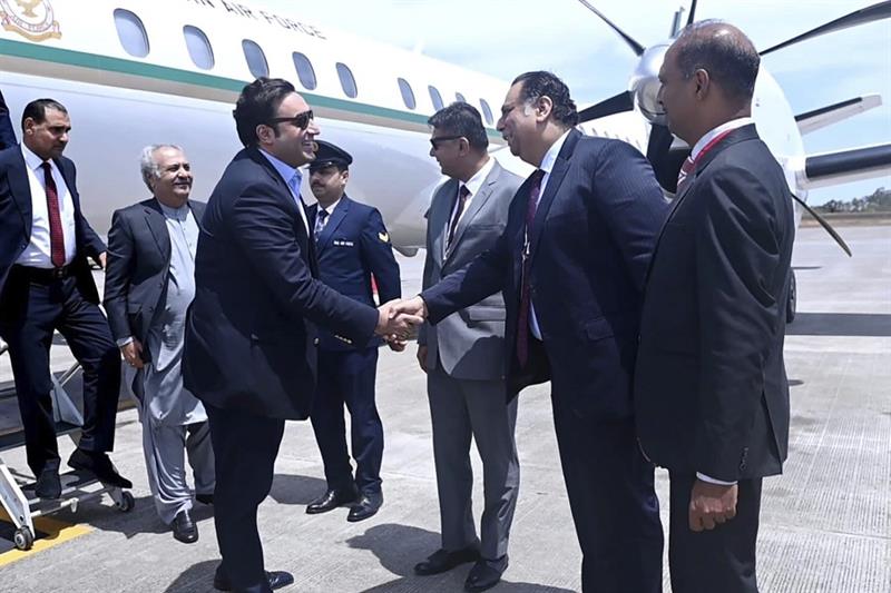 Pakistan Foreign Minister Bilawal Bhutto Zardari, third left, being received on his arrival at the G