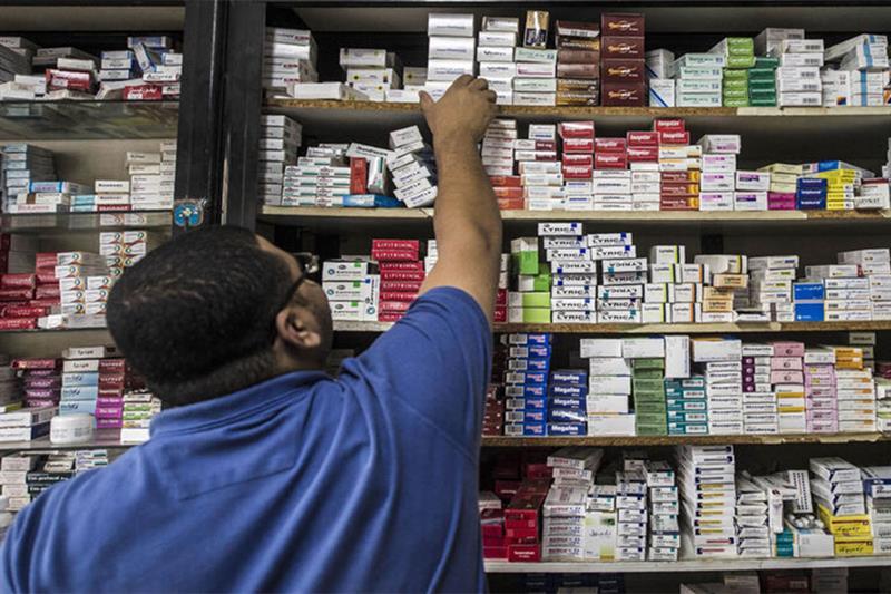 File Photo: A pharmacy employee reaches out to grab a box of medicine in a pharmacy, Cairo, Egypt. A