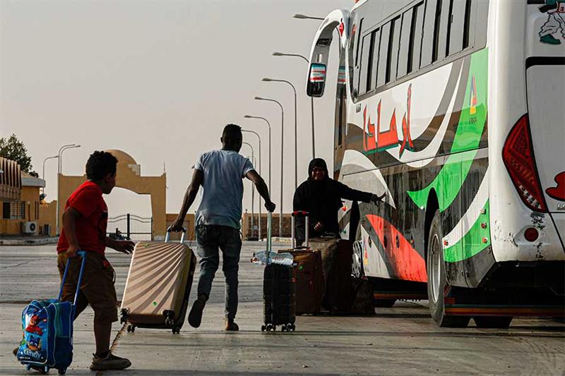 Passengers fleeing war-torn Sudan cross into Egypt through the Argeen Land Port on May 12, 2023. AFP