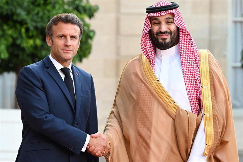 France s President Emmanuel Macron greets Saudi Crown Prince Mohammed bin Salman as he arrives at pr