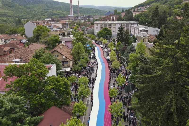People hold a giant Serbian flag during a protest in the town of Zvecan, northern Kosovo