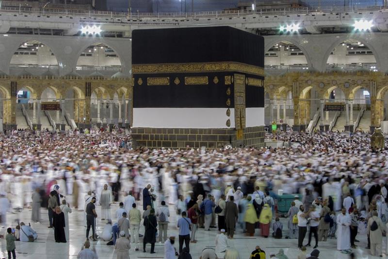 Muslim pilgrims circumambulate around the Kaaba, the cubic structure at the Grand Mosque