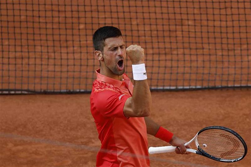 Serbia s Novak Djokovic celebrates winning his quarterfinal match of the French Open tennis tourname