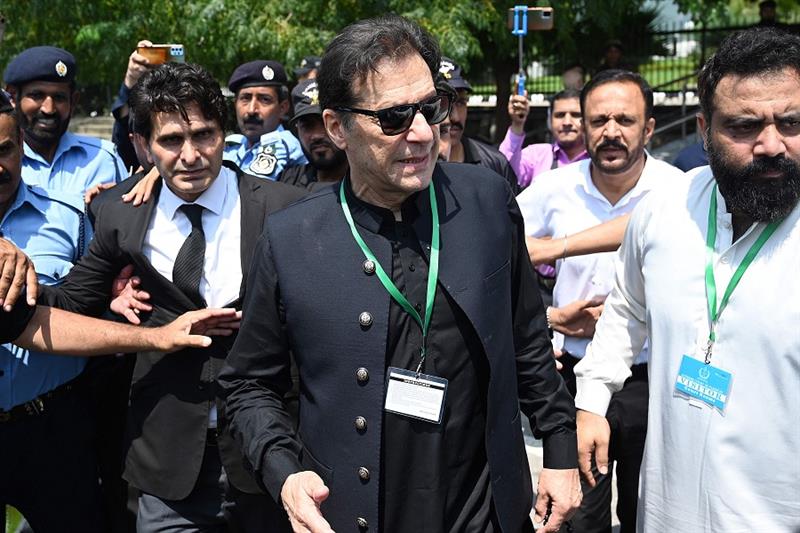 Pakistan s former Prime Minister Imran Khan (C) leaves after appearing in the Supreme Court in Islam