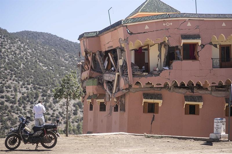A man stands next to a damaged hotel after the earthquake in Moulay Brahim village, near the epicent