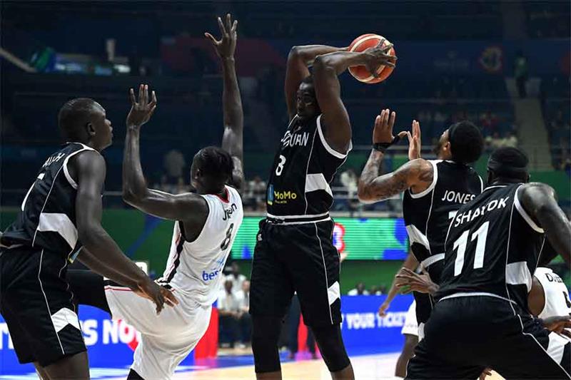 South Sudan s Kuany Ngor Kuany (C) holds the ball during the FIBA Basketball World Cup match between