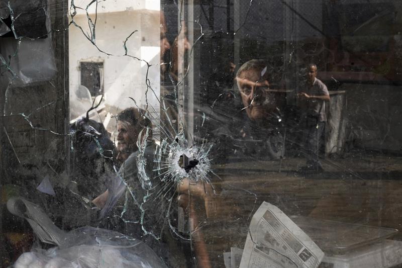 A bullet hole is seen in a shop window following an Israeli military raid in the Jenin refugee camp,