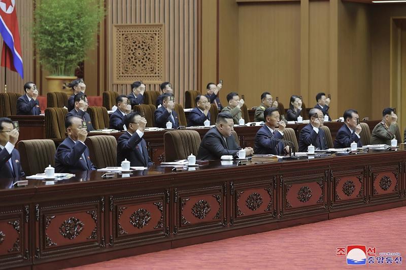 North Korean leader Kim Jong Un, bottom center, attends a meeting of the country s parliament in Pyo