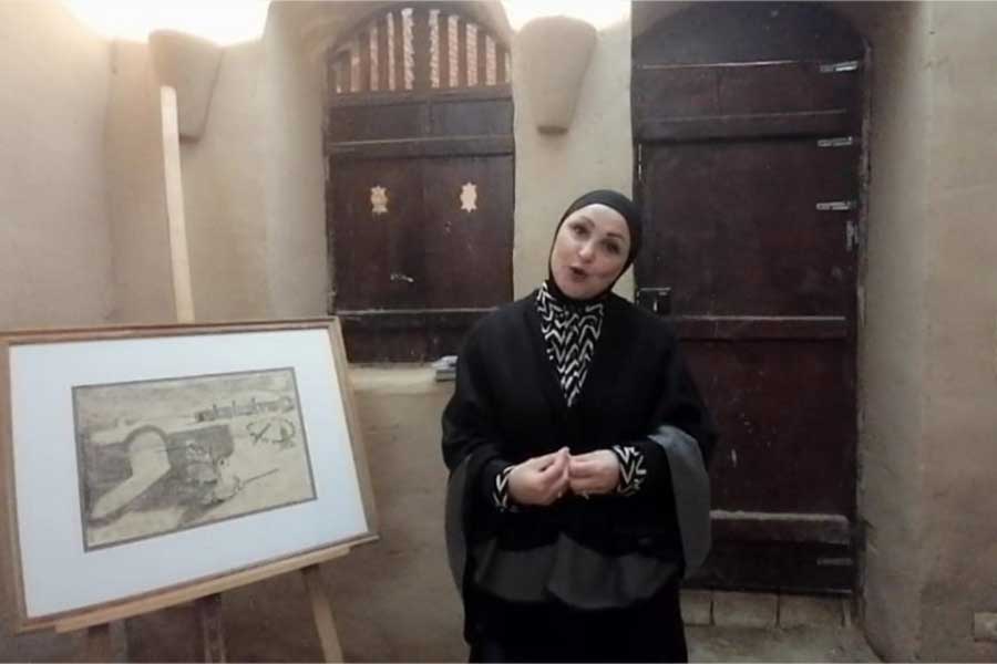 Abeer Helihal with one of the paintings of renowned painter Mammdouh Ammar