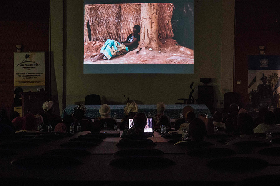People watch a film screening at the Ahmed Baba cultural centre in Timbuktu on December 06, 2021 (Photo: AFP)