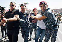 Armenian officers detain a proteser during an anti-government rally in Yerevan